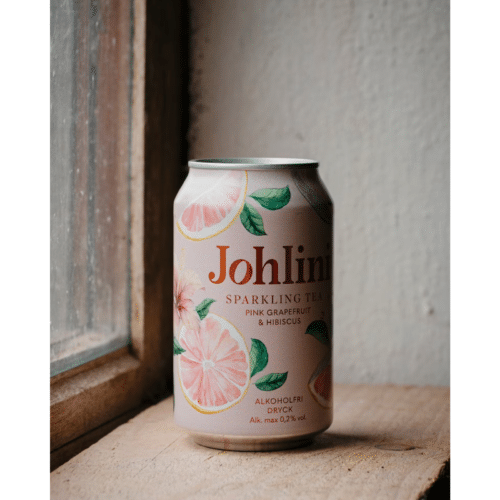 Flaska Johlini Sparkling Tea Pink Grapefruit & Hibiscus med bubbligt te, rosa citrusnyanser och elegant design