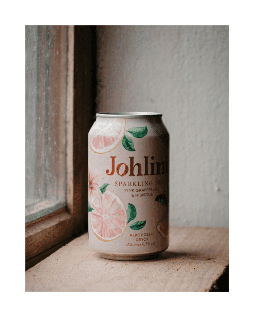 Flaska Johlini Sparkling Tea Pink Grapefruit & Hibiscus med bubbligt te, rosa citrusnyanser och elegant design